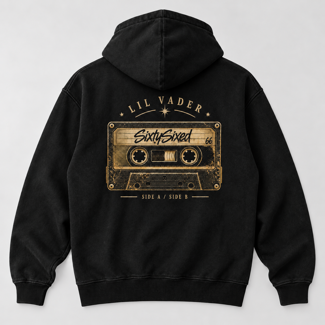 SixtySixed — Lil Vader — A gold-and-cream cassette graphic with a SixtySixed label, arranged as a bold back print on a washed black hoodie.